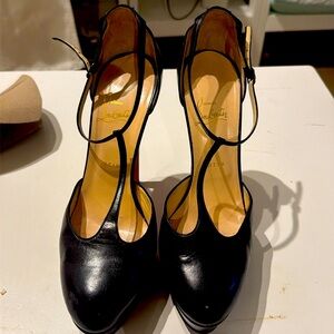 Christian Louboutin black leather platform T-bar heels.